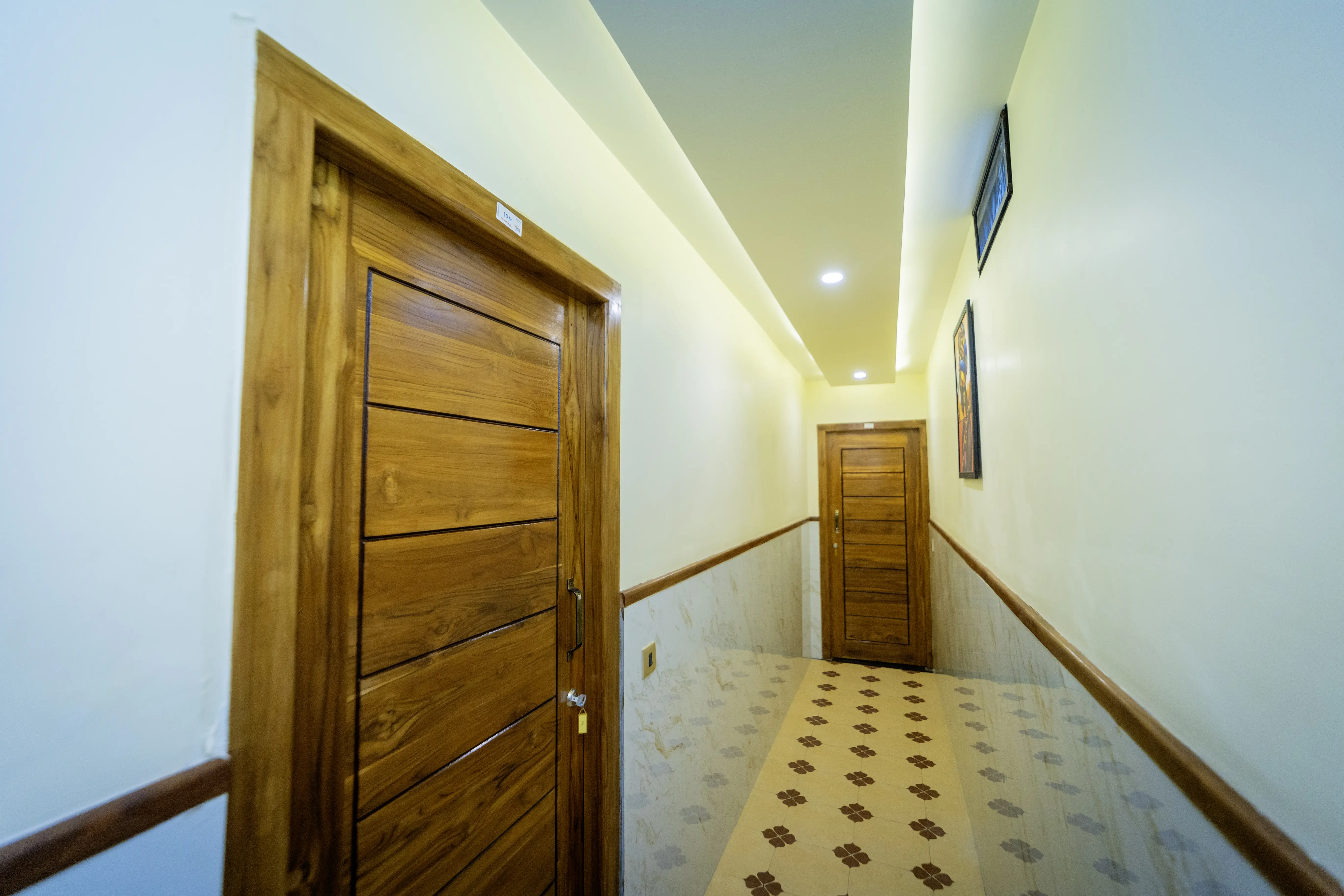 Hallway with wooden doors and patterned tile floor